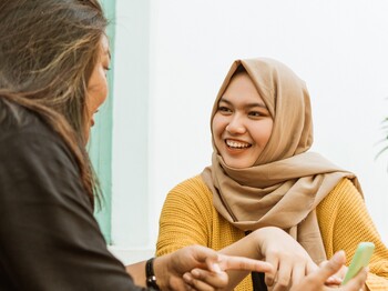 hijab girls see friends while sitting chatting in a cafe in their spare time Hijab,Girls,See,Friends,While,Sitting,Chatting,In,A,Cafe
