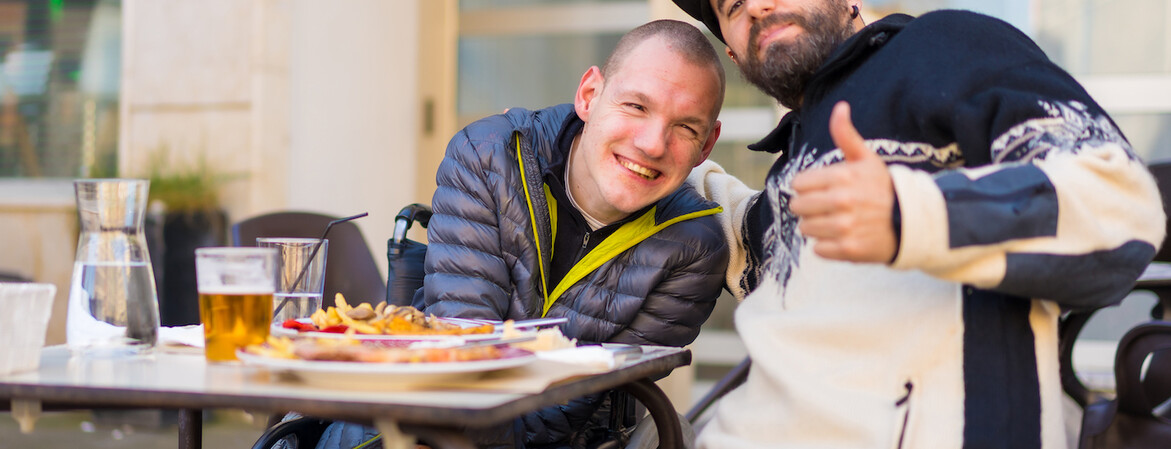 Selfie and portrait of friends eating in a restaurant terrace, disabled person eating