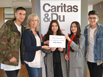 Übergabe einer Spende an die Caritas